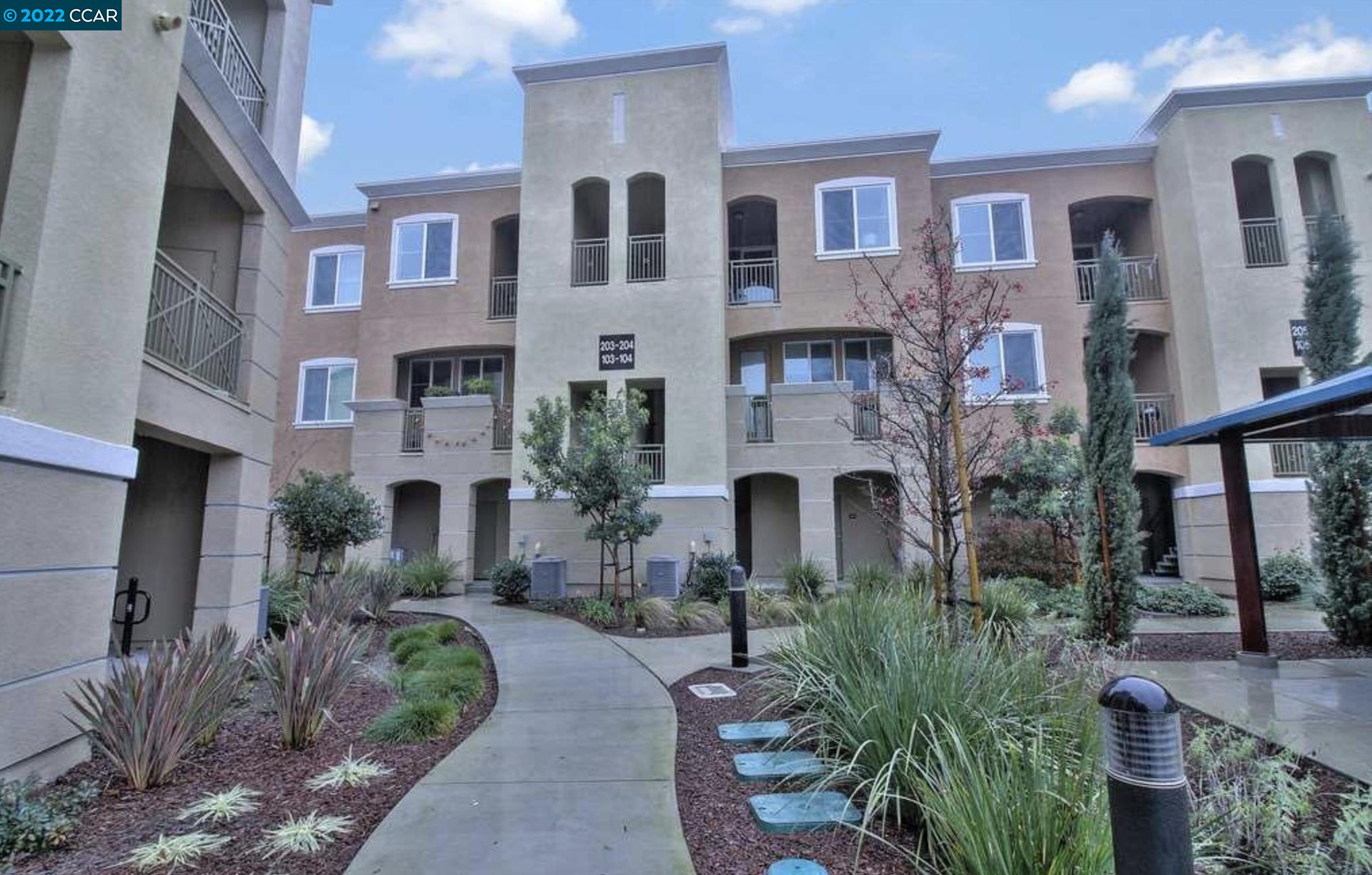 a front view of a house with yard and outdoor seating