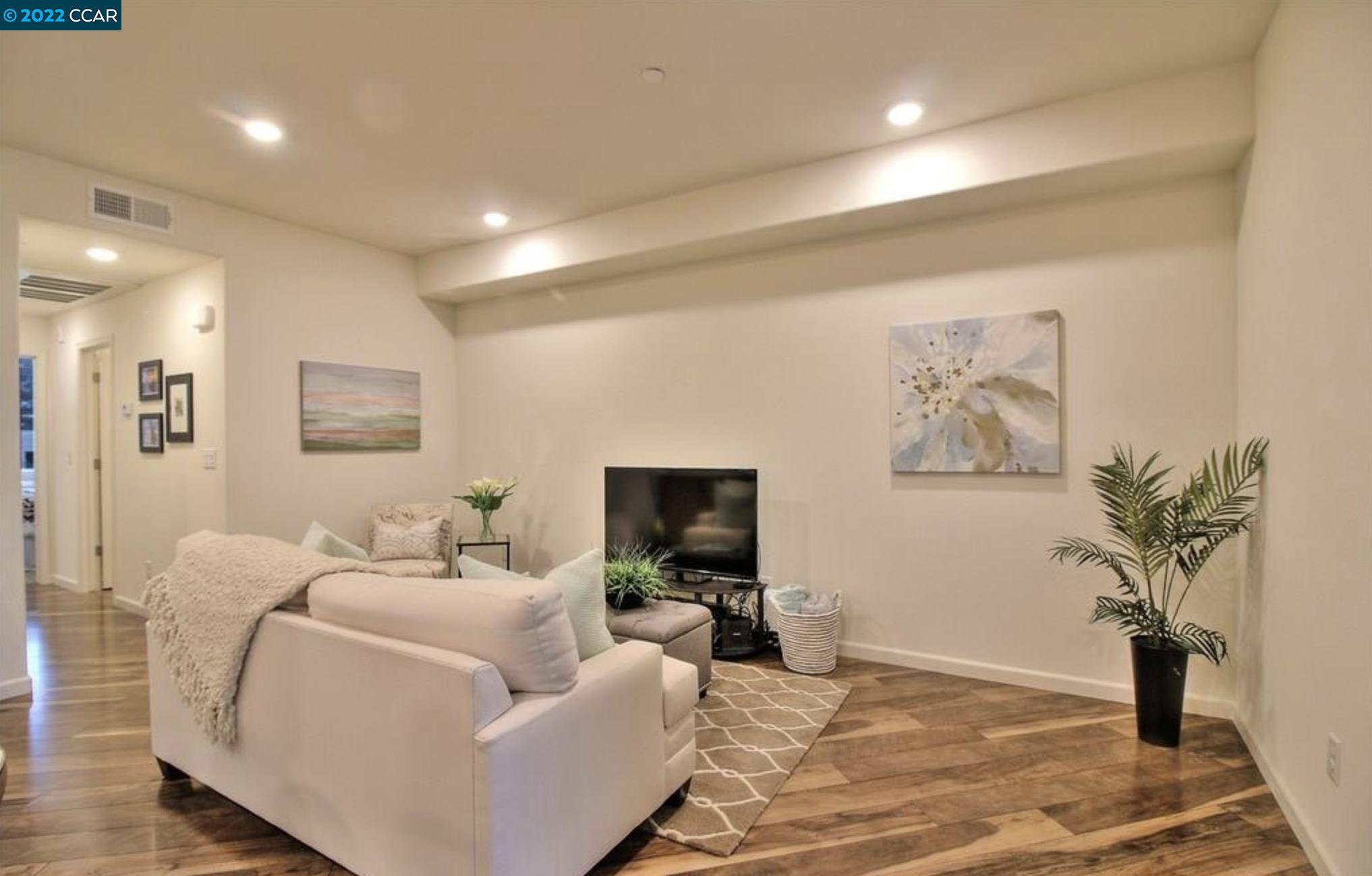 4708 Norris Canyon Road, Unit 204 San Ramon, CA 94583 - Photo 3 of 6 a living room with furniture and a flat screen tv