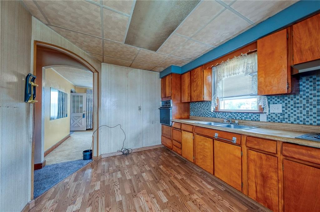 1070 Maple Avenue Washington, PA 15301 - Photo 11 of 28 a kitchen with stainless steel appliances granite countertop a sink a stove cabinets counter space and a sink
