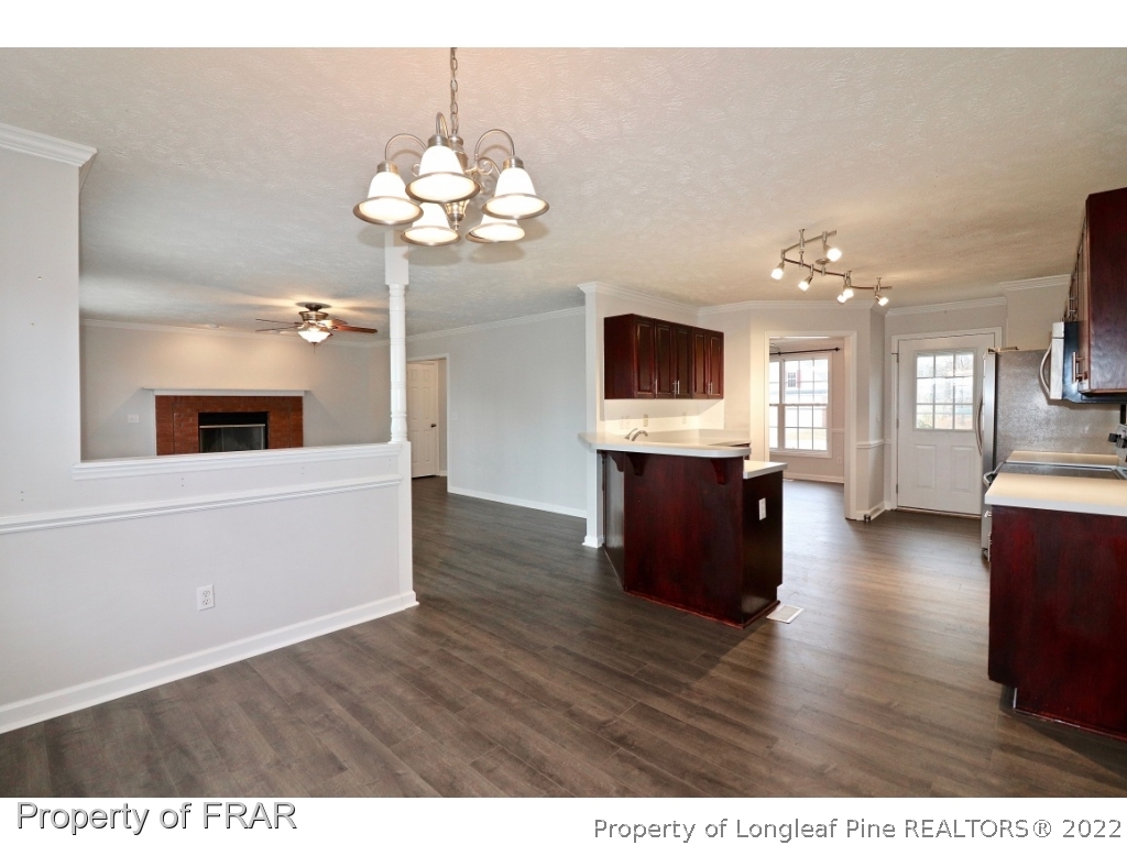 45 Chesapeake Road Cameron, NC 28326 - Photo 13 of 35 a view of a kitchen with a sink cabinet and a fireplace