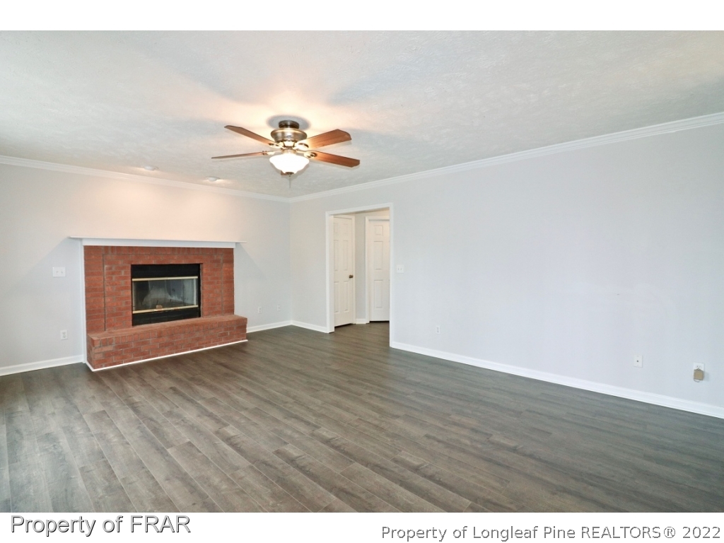 45 Chesapeake Road Cameron, NC 28326 - Photo 18 of 35 a view of an empty room with chandelier fan and wooden floor