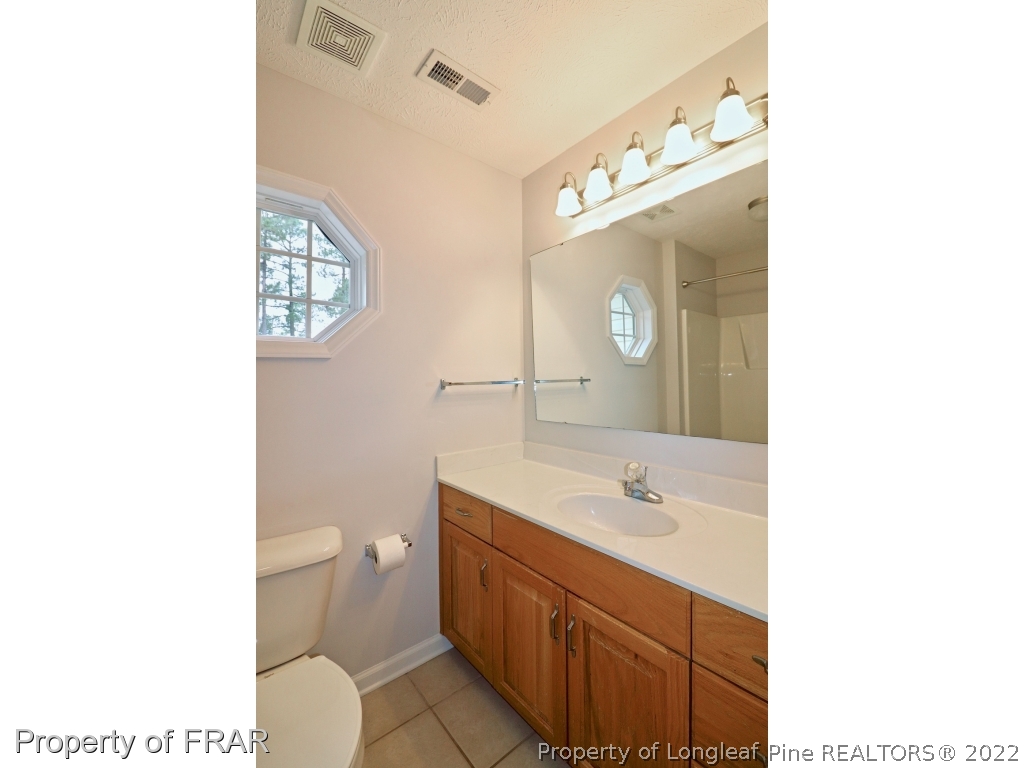 45 Chesapeake Road Cameron, NC 28326 - Photo 22 of 35 a bathroom with a sink a toilet and a mirror