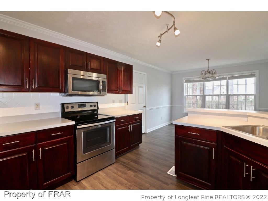 45 Chesapeake Road Cameron, NC 28326 - Photo 5 of 35 a kitchen with stainless steel appliances granite countertop a stove a sink dishwasher and a microwave