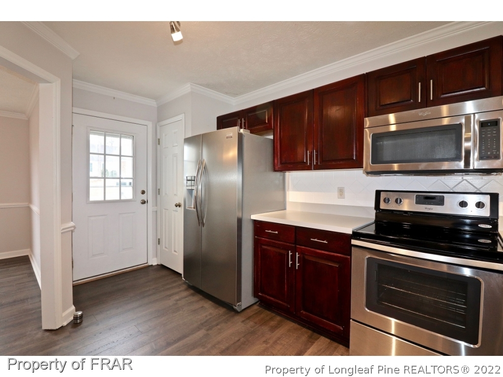 45 Chesapeake Road Cameron, NC 28326 - Photo 6 of 35 a kitchen with stainless steel appliances and wooden cabinets