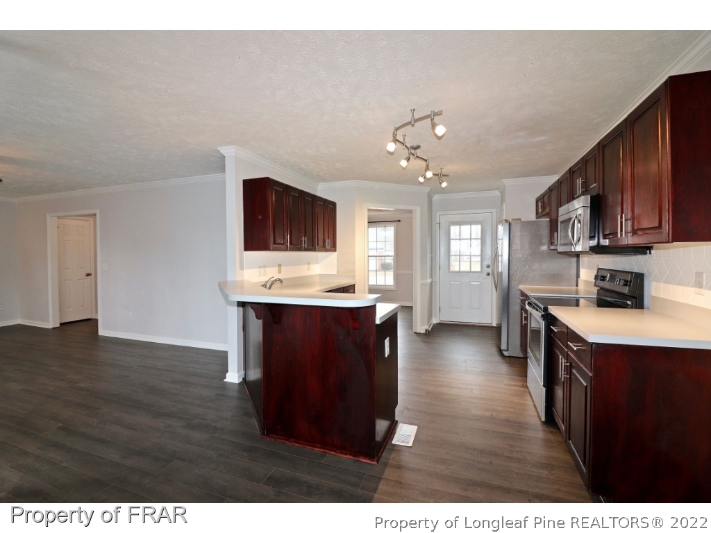 45 Chesapeake Road Cameron, NC 28326 - Photo 8 of 35 a open kitchen with kitchen island granite countertop cabinets and wooden floor