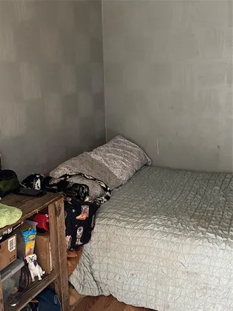 a bedroom with a bed and a dresser