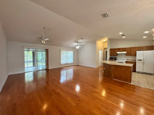 a view of a house with backyard sitting area and garden