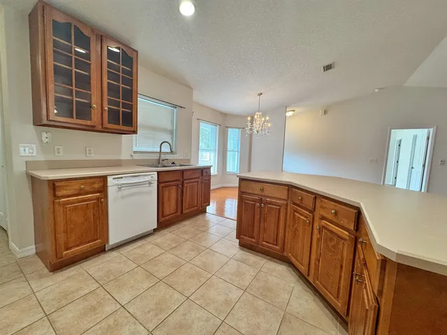 an empty room with windows and ceiling fan