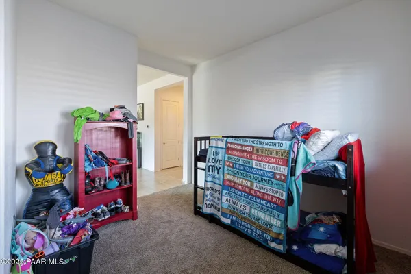 a bed sitting in a bedroom next to a window