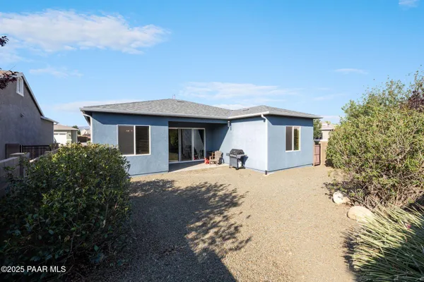 an aerial view of a city with lots of residential buildings and mountain view in back