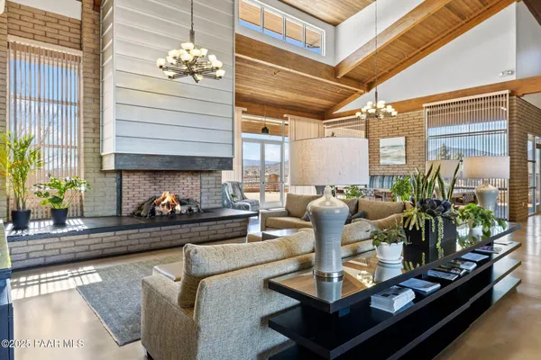 a living room with fireplace furniture and a flat screen tv
