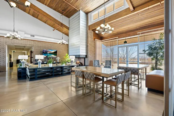 a view of a swimming pool with outdoor seating and plants