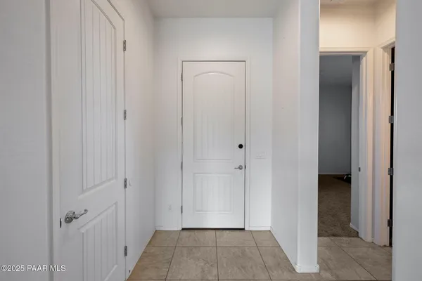 a living room with furniture and a view of kitchen