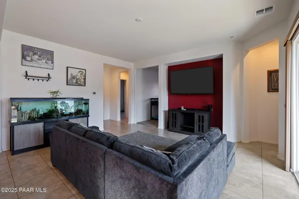 a kitchen with granite countertop stainless steel appliances a stove top oven a sink a dining table and chairs