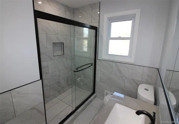 a bathroom with a shower and toilet