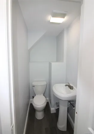 a white toilet sitting next to a white sink