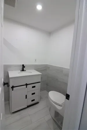 a bathroom with a sink a toilet and a mirror