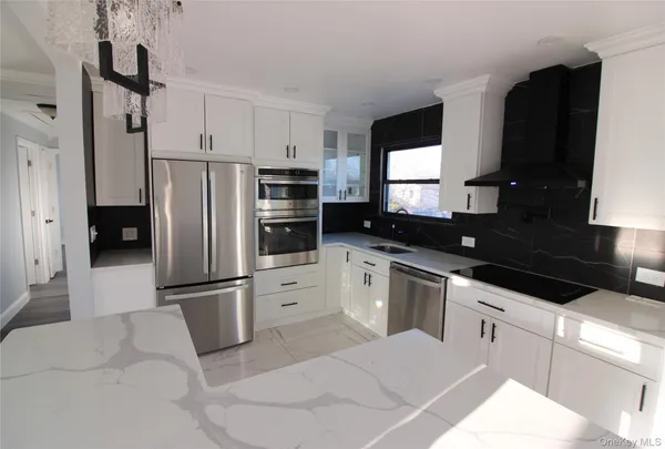 a kitchen with stainless steel appliances a refrigerator sink and microwave