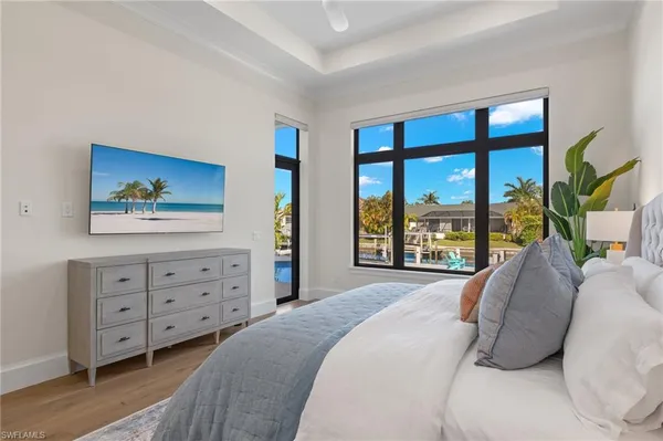 a bed sitting in a bedroom next to a window