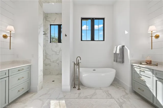 a bedroom with a large bed and a potted plant