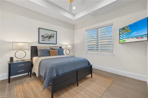 a bedroom with a large bed and a large window