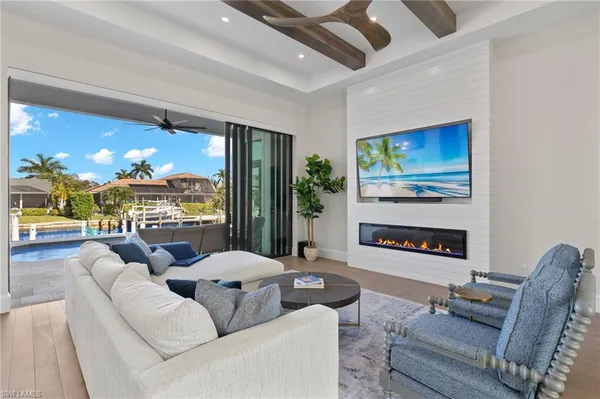 a living room with furniture a fireplace and a flat screen tv