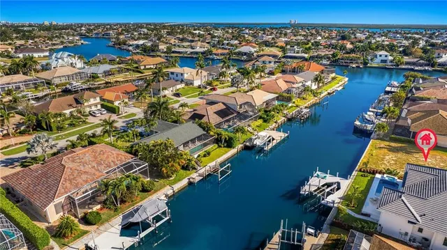 a view of a house with pool and chairs
