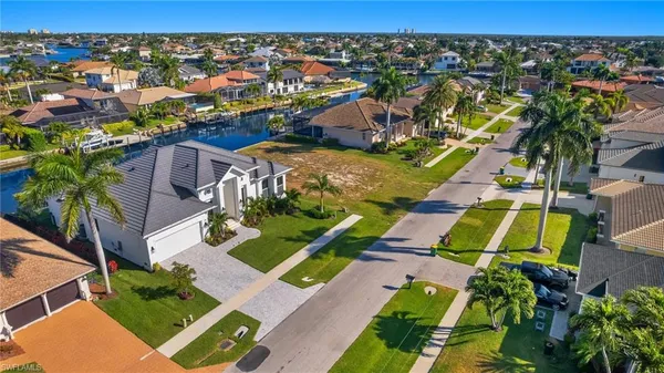 an aerial view of residential houses with outdoor space and swimming pool