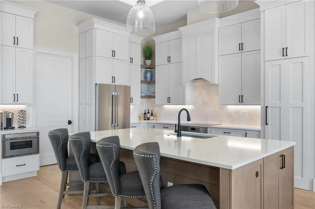 a kitchen with stainless steel appliances a sink stove and refrigerator