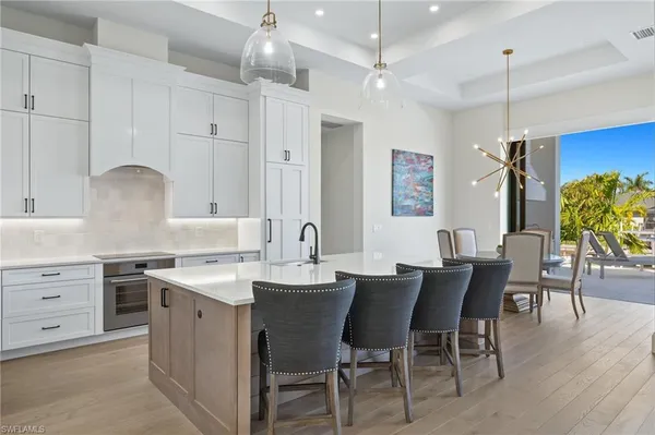 a view of kitchen with sink dining table and chairs