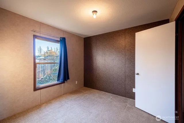 an empty room with windows and closet