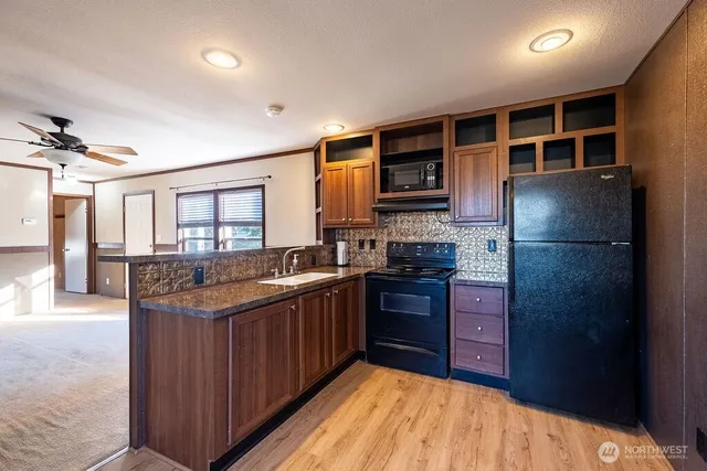 a kitchen with stainless steel appliances granite countertop a refrigerator and a sink