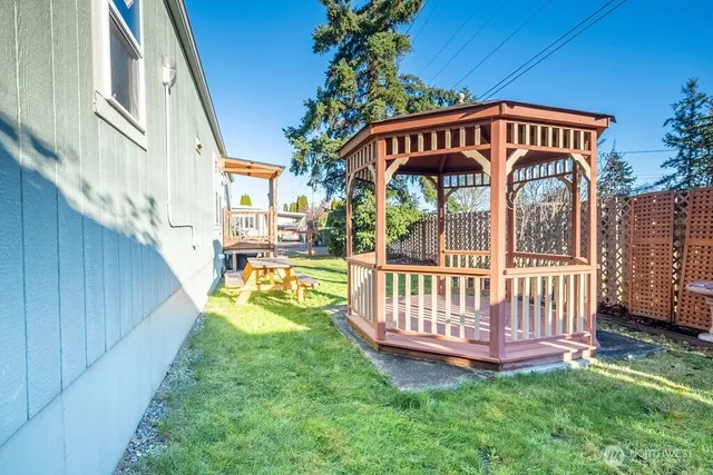 a view of a house with a yard deck and furniture
