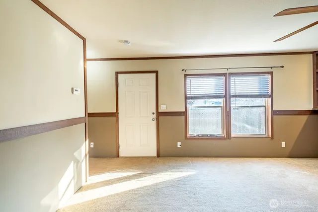 an empty room with windows and closet