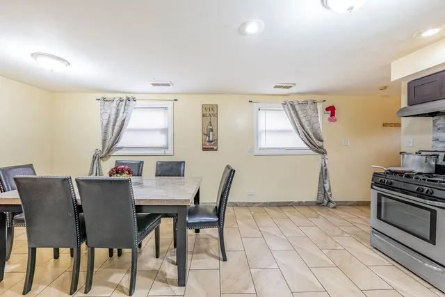 a view of a dining room with furniture and a window
