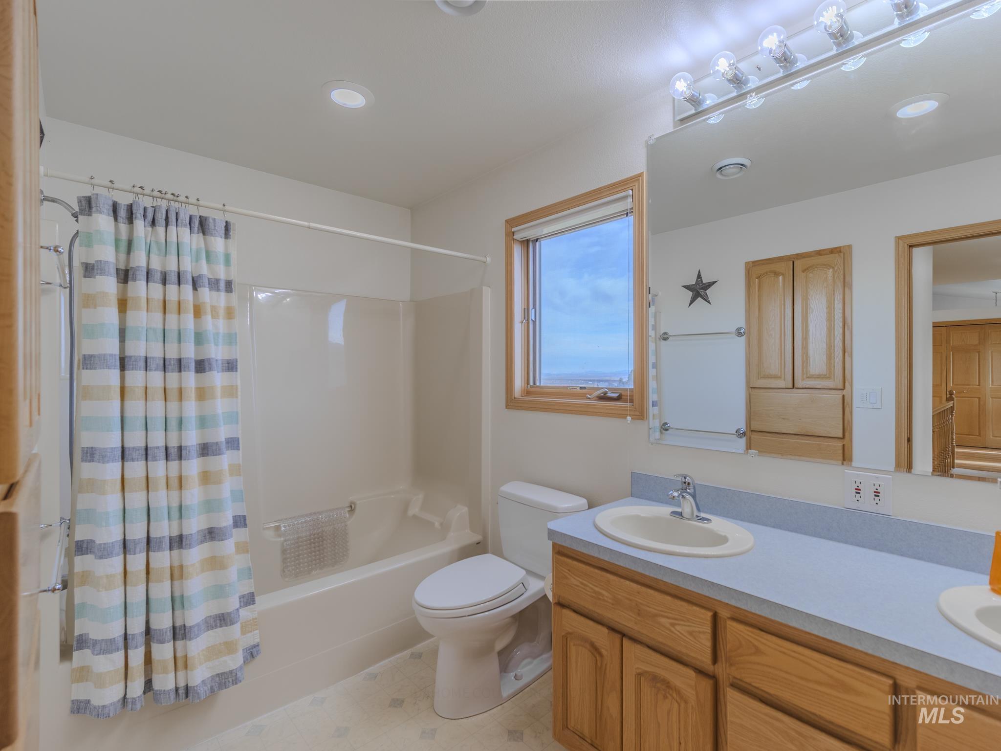 202 Fish Hatchery Road Grangeville, ID 83530 - Photo 25 of 50 Full bath with shower / bath combo with shower curtain, double vanity, and recessed lighting