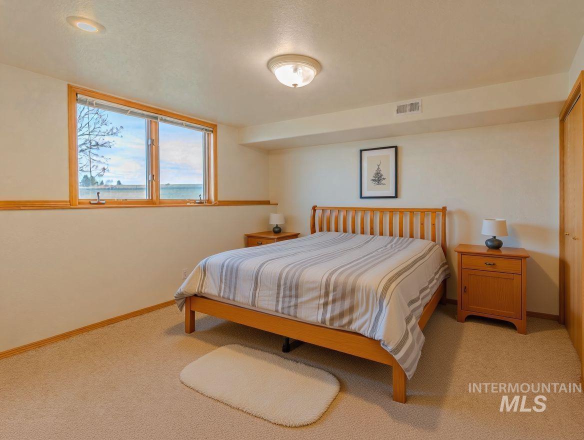 202 Fish Hatchery Road Grangeville, ID 83530 - Photo 35 of 50 Bedroom with light colored carpet and a textured ceiling