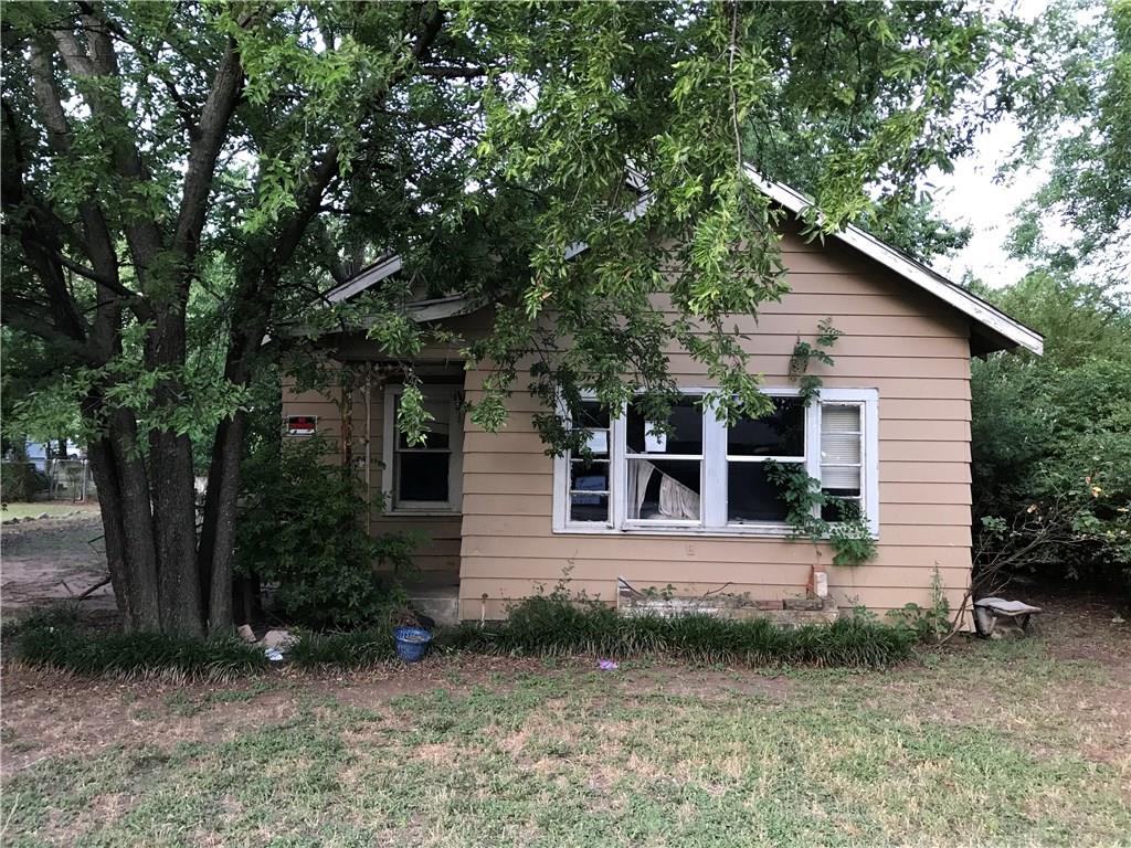 a view of house with backyard space and garden