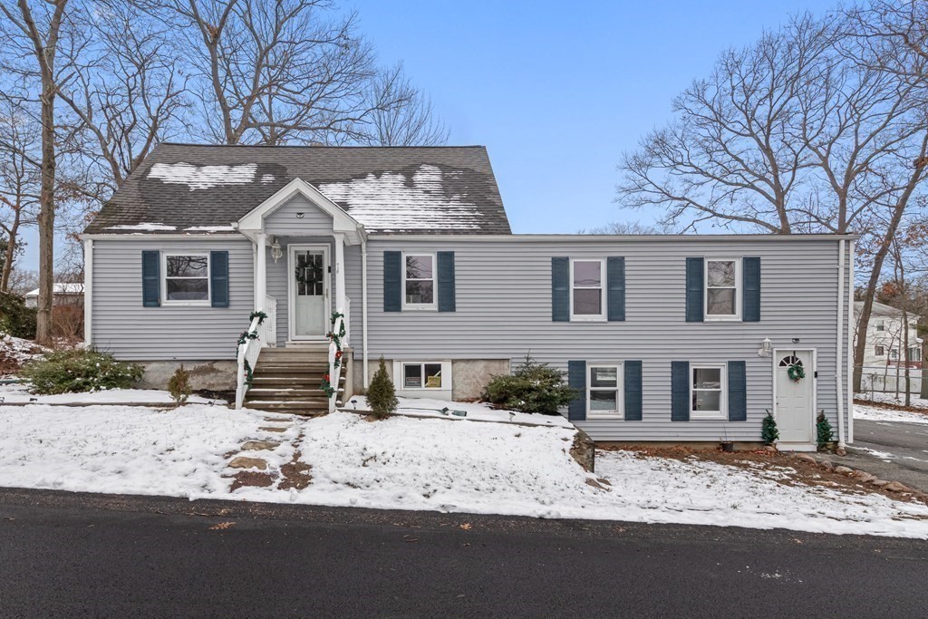 76 Rockefeller Street Randolph, MA 02368 - Photo 1 of 40 a front view of a house with a yard covered in snow
