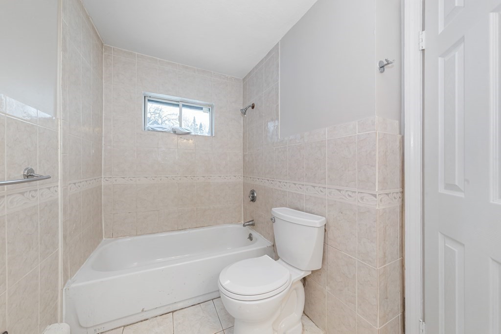 76 Rockefeller Street Randolph, MA 02368 - Photo 12 of 40 a white toilet sitting next to a bath tub