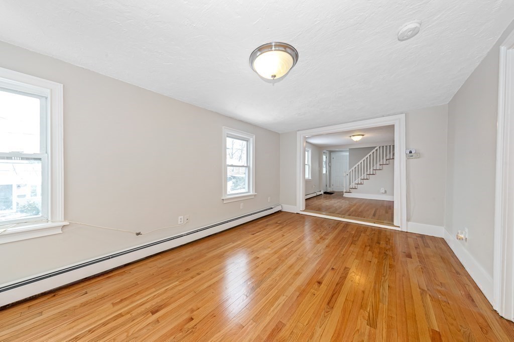 76 Rockefeller Street Randolph, MA 02368 - Photo 16 of 40 a view of empty room with wooden floor and fan
