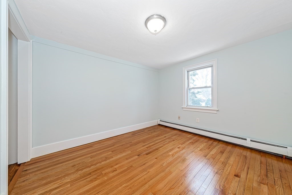 76 Rockefeller Street Randolph, MA 02368 - Photo 19 of 40 an empty room with wooden floor and windows