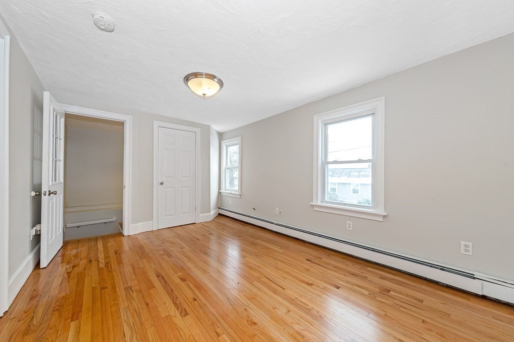 76 Rockefeller Street Randolph, MA 02368 - Photo 21 of 40 a view of an empty room with wooden floor and a window