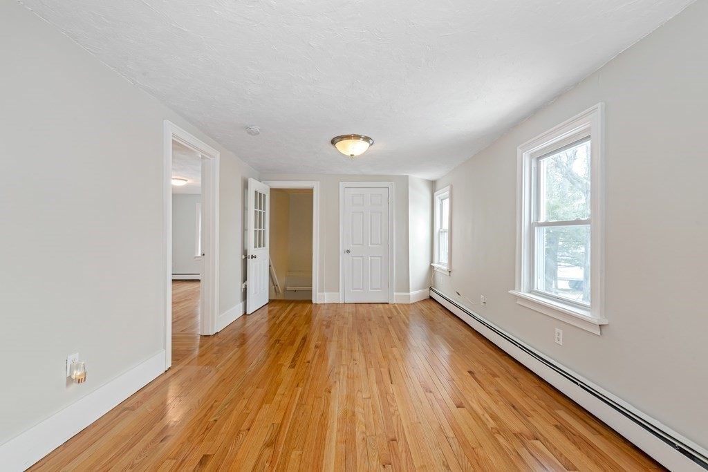 76 Rockefeller Street Randolph, MA 02368 - Photo 22 of 40 a view of an empty room with wooden floor and a window