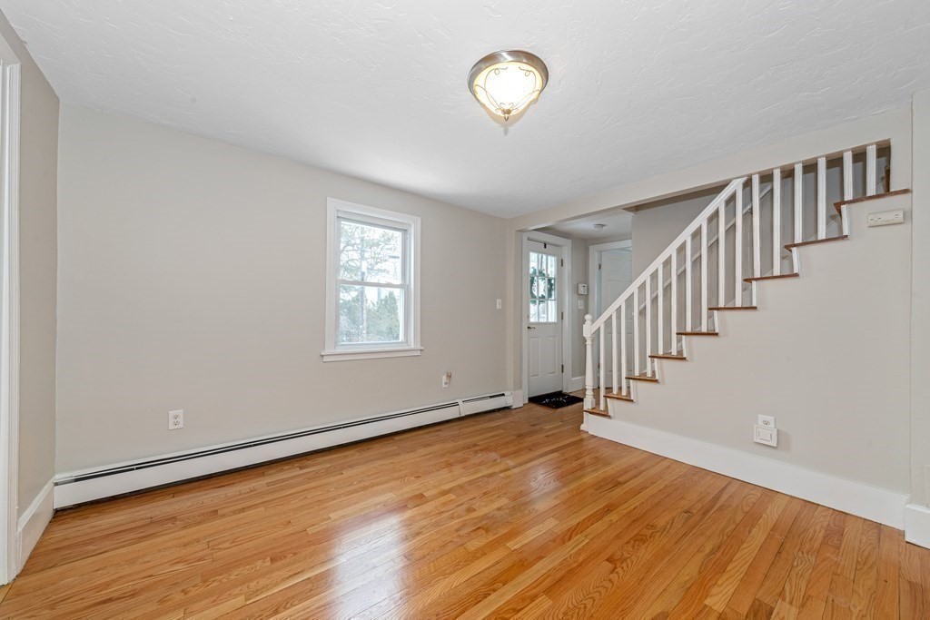 76 Rockefeller Street Randolph, MA 02368 - Photo 24 of 40 a view of an empty room with wooden floor and a window