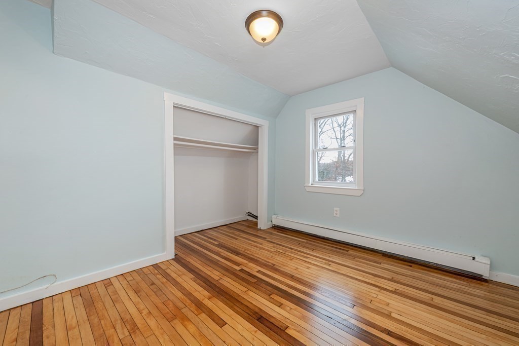 76 Rockefeller Street Randolph, MA 02368 - Photo 26 of 40 a view of an empty room with wooden floor and a window