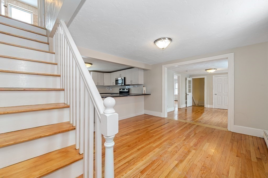 76 Rockefeller Street Randolph, MA 02368 - Photo 29 of 40 a view of a kitchen with wooden floor and stairs
