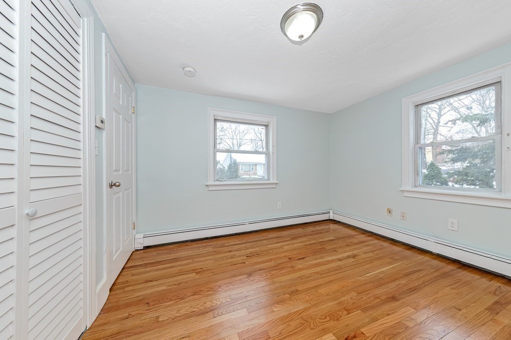 76 Rockefeller Street Randolph, MA 02368 - Photo 32 of 40 an empty room with wooden floor and windows
