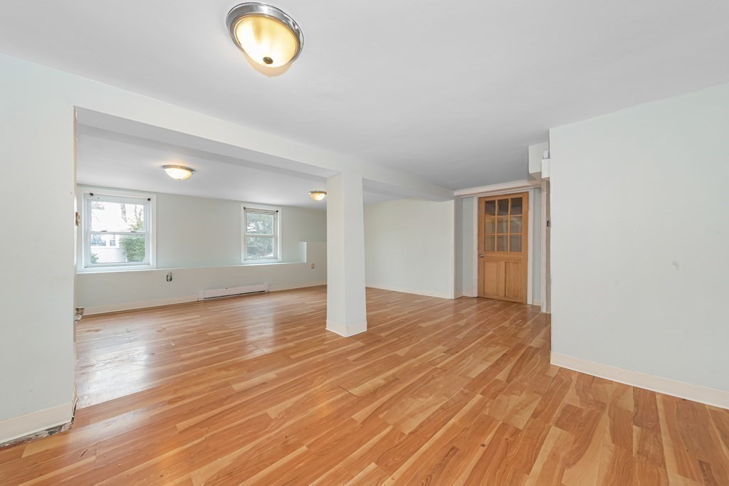 76 Rockefeller Street Randolph, MA 02368 - Photo 35 of 40 an empty room with wooden floor and windows