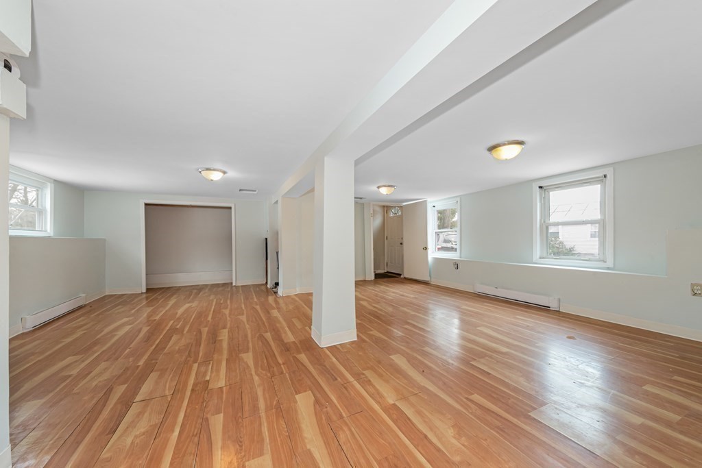 76 Rockefeller Street Randolph, MA 02368 - Photo 36 of 40 a view of empty room with wooden floor and fan